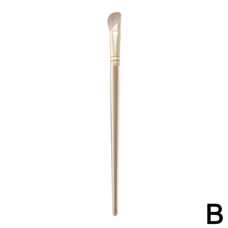 Champagne-colored half-fan-shaped sickle nose shadow brush, angled tip for blending highlighter, contour, and shading. Soft bristles.